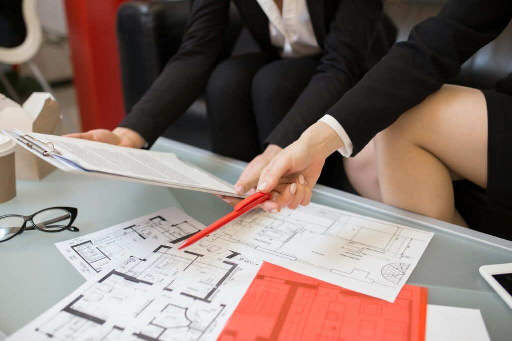 Table with House Plans in Real Estate Agency